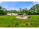 Scenic backyard featuring a cozy firepit area, outdoor seating, and a well-maintained lawn at 8000 Mcwhorter Rd, Martinsville, IN 46151