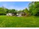 Spacious backyard with a wooden patio, hot tub, and a custom-built enclosed catio at 8000 Mcwhorter Rd, Martinsville, IN 46151