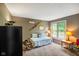 A cozy bedroom features carpet, neutral paint, a window, and a daybed with decorative pillows at 8000 Mcwhorter Rd, Martinsville, IN 46151