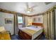 Charming bedroom featuring blue textured walls, a ceiling fan, and a wooden bed frame at 8000 Mcwhorter Rd, Martinsville, IN 46151