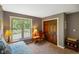 A neutral bedroom is brightened by a large window and has a wooden closet at 8000 Mcwhorter Rd, Martinsville, IN 46151