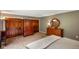 Bedroom with neutral walls, plush carpet, and antique wooden dresser at 8000 Mcwhorter Rd, Martinsville, IN 46151