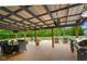 Spacious covered patio with an outdoor table, chairs, lounge furniture, and a grill at 8000 Mcwhorter Rd, Martinsville, IN 46151