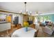 Dining room with chandelier, white table cloth, and view into living room and kitchen at 8000 Mcwhorter Rd, Martinsville, IN 46151