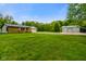 Well-maintained home featuring a large front yard, two-car garage, and a detached garage at 8000 Mcwhorter Rd, Martinsville, IN 46151