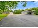 Exterior of property with long driveway, storage shed, car port, and two-car attached garage at 8000 Mcwhorter Rd, Martinsville, IN 46151