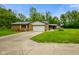 Ranch style house with attached two-car garage and wooden deck with chairs at 8000 Mcwhorter Rd, Martinsville, IN 46151