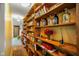 Hallway lined with floor to ceiling wooden shelving for displaying decor and books at 8000 Mcwhorter Rd, Martinsville, IN 46151