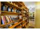 Charming hallway featuring a large custom-built shelving unit with decorations and books at 8000 Mcwhorter Rd, Martinsville, IN 46151