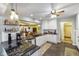 Open kitchen with white cabinets, dark granite countertops, and stainless steel appliances at 8000 Mcwhorter Rd, Martinsville, IN 46151