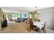 Open-concept living room and dining area with large windows and neutral tones at 8000 Mcwhorter Rd, Martinsville, IN 46151