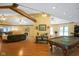 Living room featuring wood floors, a fireplace, and a pool table at 8000 Mcwhorter Rd, Martinsville, IN 46151