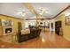 Spacious living room with a fireplace, ceiling fans, and hardwood floors at 8000 Mcwhorter Rd, Martinsville, IN 46151
