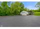 Large outbuilding with a garage door and covered parking area at 8000 Mcwhorter Rd, Martinsville, IN 46151