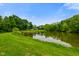 Picturesque pond view from the grassy lawn at 8000 Mcwhorter Rd, Martinsville, IN 46151