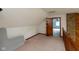Finished attic space featuring plush carpet, natural light, and wood trim at 8465 Hilltop Ln, Martinsville, IN 46151