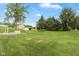 Lush, well-maintained backyard with green grass and mature trees at 8465 Hilltop Ln, Martinsville, IN 46151