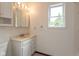 Bathroom with white sink, mirror with lighting, towel rack and bright natural light at 8465 Hilltop Ln, Martinsville, IN 46151