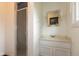 Bright bathroom featuring a shower with glass door, vanity, mirror and lighting at 8465 Hilltop Ln, Martinsville, IN 46151