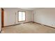 Bare bedroom featuring carpeted floors, a large window and baseboard trim at 8465 Hilltop Ln, Martinsville, IN 46151