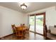 Inviting dining area with wood table, chairs, and sliding door to the deck at 8465 Hilltop Ln, Martinsville, IN 46151