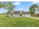 Charming stone home with a well-manicured lawn, attached garage, and lovely curb appeal at 8465 Hilltop Ln, Martinsville, IN 46151