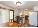 Eat-in kitchen featuring a breakfast bar, white cabinets, and appliances at 8465 Hilltop Ln, Martinsville, IN 46151