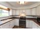 Well-lit kitchen featuring a range, sink and light wood cabinets at 8465 Hilltop Ln, Martinsville, IN 46151
