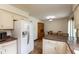Spacious kitchen area with full-size refrigerator, appliances, and dining set at 8465 Hilltop Ln, Martinsville, IN 46151