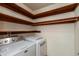Functional laundry area with modern washer and dryer, ample storage shelves, and efficient design at 8465 Hilltop Ln, Martinsville, IN 46151