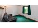 Cozy living room features a comfortable black leather sofa and a bright window at 8465 Hilltop Ln, Martinsville, IN 46151