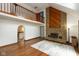 Open-concept living area with hardwood floors, fireplace, and an arched doorway at 8465 Hilltop Ln, Martinsville, IN 46151