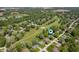 Aerial view of a charming community with a golf course and a serene pond at 9104 W Lone Beech Dr, Muncie, IN 47304