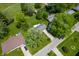 Aerial view of home and neighborhood with mature trees and green lawns at 9104 W Lone Beech Dr, Muncie, IN 47304