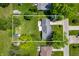Aerial view of property with a well-maintained lawn and mature trees at 9104 W Lone Beech Dr, Muncie, IN 47304