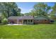 Spacious backyard featuring a well-maintained lawn, patio, and access to the sun room at 9104 W Lone Beech Dr, Muncie, IN 47304