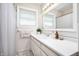 Bright bathroom featuring a white vanity with ample counter space and a large mirror at 9104 W Lone Beech Dr, Muncie, IN 47304