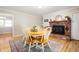 Charming dining area with a brick fireplace and ample seating at 9104 W Lone Beech Dr, Muncie, IN 47304
