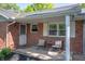 Inviting front porch with seating area and charming decor at 9104 W Lone Beech Dr, Muncie, IN 47304