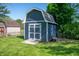 Well-maintained blue shed with white trim, offering ample outdoor storage space at 9104 W Lone Beech Dr, Muncie, IN 47304