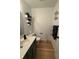 Comfortable half-bathroom featuring tiled floors, decorative shelves, and a vanity with an oval sink at 9535 Longwell Dr, Indianapolis, IN 46240
