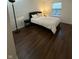 Bedroom with hardwood flooring, a large window, and a simple, cozy decor at 9535 Longwell Dr, Indianapolis, IN 46240