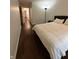 Bedroom with hardwood flooring, a large window, and a simple, cozy decor at 9535 Longwell Dr, Indianapolis, IN 46240