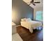 Bright bedroom with a comfortable bed, modern ceiling fan, and a large window at 9535 Longwell Dr, Indianapolis, IN 46240