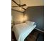 Bedroom with a ceiling fan, dresser, and large windows for natural light at 9535 Longwell Dr, Indianapolis, IN 46240