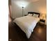 Bedroom with hardwood flooring, a large window, and a simple, cozy decor at 9535 Longwell Dr, Indianapolis, IN 46240
