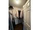 Walk-in closet with hanging clothing and storage shelves at 9535 Longwell Dr, Indianapolis, IN 46240