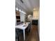 Open dining room with a modern chandelier and fireplace, connecting to other living spaces at 9535 Longwell Dr, Indianapolis, IN 46240