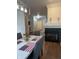 Cozy dining area with a modern light fixture, fireplace, and seating for six at 9535 Longwell Dr, Indianapolis, IN 46240