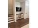Inviting entryway with hardwood floors, staircase, and a stylish media cabinet at 9535 Longwell Dr, Indianapolis, IN 46240